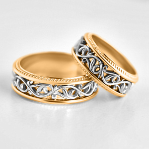 Золотые двухцветные обручальные кольца с рельефным узором (Вес пары 19 гр.)