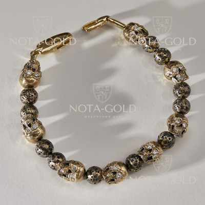 Золотой браслет с черепами, бусинами в виде вулканической лавы и бриллиантами (цена за грамм)